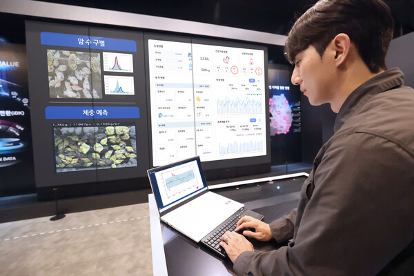  LG유플러스 임직원이 AI 양계 스마트팜 서비스를 시연하는 장면.